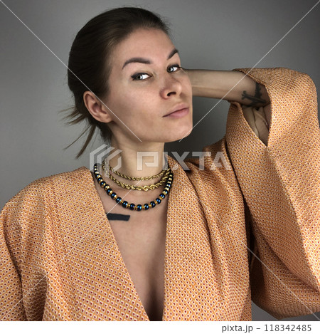 Portrait of a young woman in unusual massive jewelry Portrait of a young woman in unusual massive jewelry 118342485