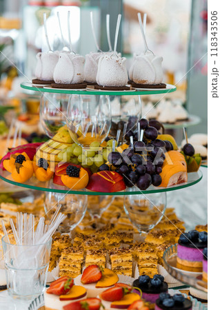 Exquisite Dessert Buffet: A Symphony of Delectable Treats and Fresh Fruits Exquisite Dessert Buffet: A Symphony of Delectable Treats and Fresh Fruits 118343506