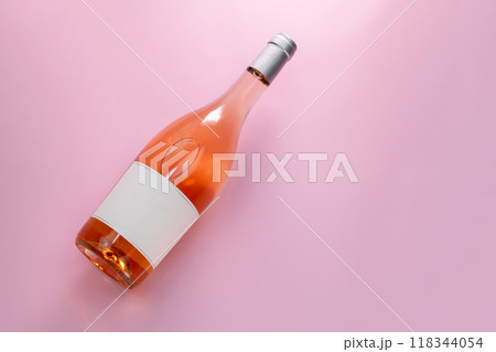 Wine bottle mockup, unopened bottle of rose wine on pink background, top view, copy space, flat lay 118344054