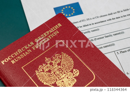 Russian travel passport with Schengen visa application form, sanctions, emigration, immigration, tourism concept 118344364
