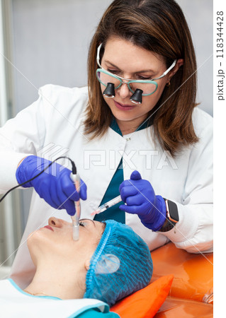 Application of an anti-aging facial rejuvenation cocktail using micro needles. Dermatology concept. Aesthetic medicine concept. 118344428