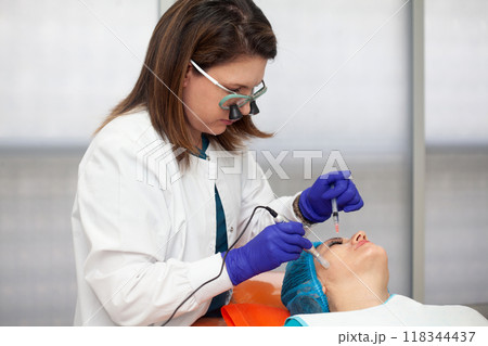 Application of an anti-aging facial rejuvenation cocktail using micro needles. Dermatology concept. Aesthetic medicine concept. 118344437