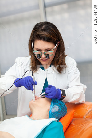 Application of an anti-aging facial rejuvenation cocktail using micro needles. Dermatology concept. Aesthetic medicine concept. Application of an anti-aging facial rejuvenation cocktail using micro needles. Dermatology concept. Aesthetic medicine concept. 118344439