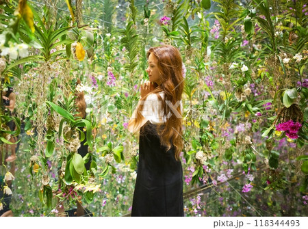 A girl stands in the center of an abundance of fresh flowers, Japan, TIMELAB A girl stands in the center of an abundance of fresh flowers, Japan, TIMELAB 118344493