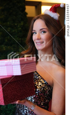 Girl holding a box with a gift red color Girl holding a box with a gift red color 118344497