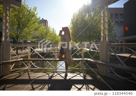 A girl poses in a gazebo at sunset in Zaandam, Netherlands 118344540