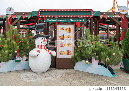 Festive winter market with snowman and food court in amusement park setting 118345538