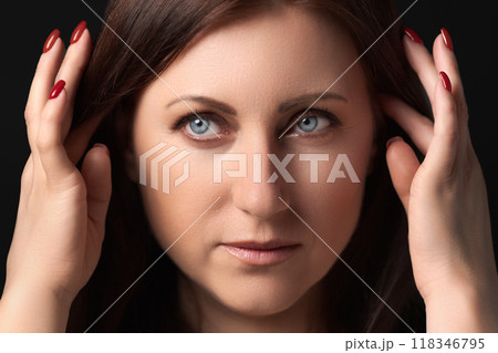 Extreme closeup of thoughtful woman with personal problems on her mind. Headshot of adult female with headache, hands raised near head and looking away. Concept mental health, stress and depression 118346795