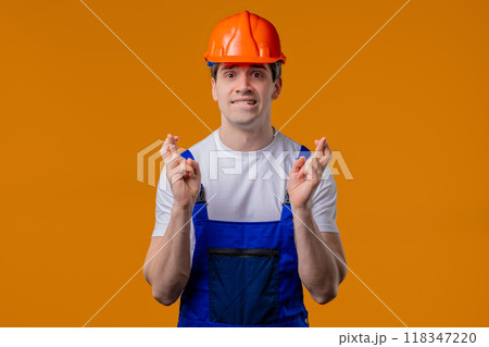 Mature construction builder man praying on orange studio. Hopeful Prayer, belief 118347220