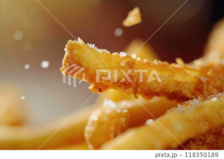 Crispy French Fry with Salt Crystals and Chicken Finger in Background 118350189