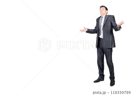 Confused male worker shrugging shoulders in studio 118350789