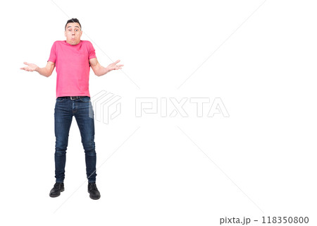 Young male shrugging shoulders and looking puzzled in studio Young male shrugging shoulders and looking puzzled in studio 118350800