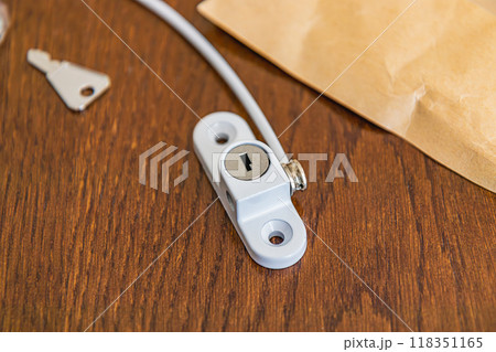 Close up A set of child safety window locks is on the table Close up A set of child safety window locks is on the table 118351165