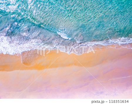 Top view waves crashing on sandy shore, Beach sea space nature background Top view waves crashing on sandy shore, Beach sea space nature background 118351634