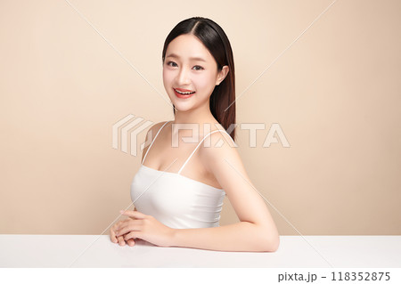 Beautiful young asian woman with clean fresh skin on beige background, Face care, Facial treatment, Cosmetology, beauty and spa, Asian women portrait. 118352875