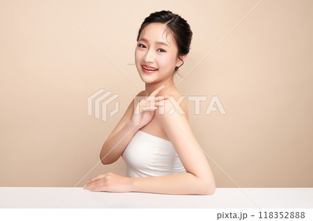 Beautiful young asian woman with clean fresh skin on beige background, Face care, Facial treatment, Cosmetology, beauty and spa, Asian women portrait. 118352888