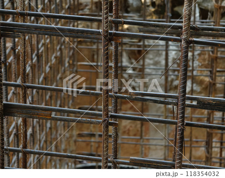 A construction site displaying a reinforced concrete foundation with steel rebar 118354032