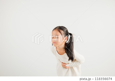 Portrait of Asian young kid girl has stomachache, kindergarten child abdominal pain suffering from stomach ache, studio shot isolated on white background, food poisoning, Health and medical gastritis 118356074