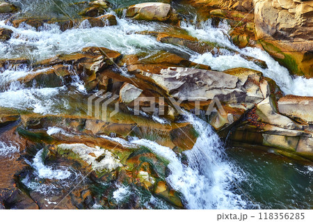 The flow of a mountain river among the stone rocks 118356285