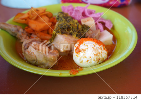 A colorful Lontong Padang dish featuring rice cake, chicken. A colorful Lontong Padang dish featuring rice cake, chicken. 118357514