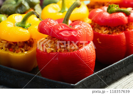 Baked stuffed pepper ( paprika ) with rice , carrot and meat . Top view on rustic background 118357639
