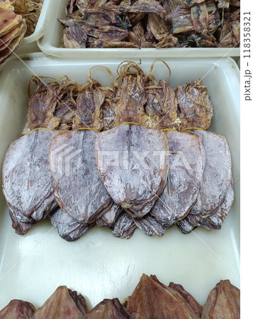 dried squid on plastic tray for sale in Thai local market 118358321