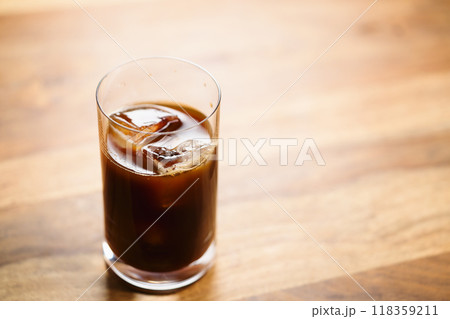 Glass of iced coffee on wooden table 118359211