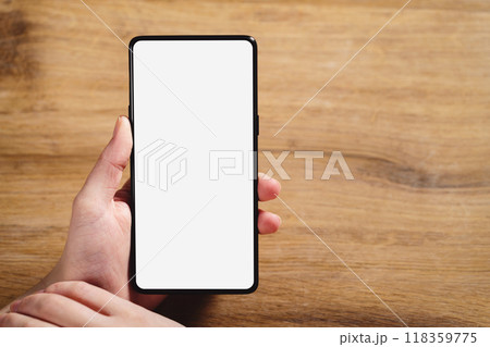 female teen hand holding smartphone with blank white screen 118359775