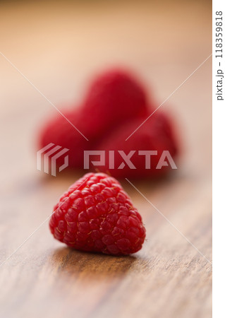 Ripe raspberries on wood background 118359818