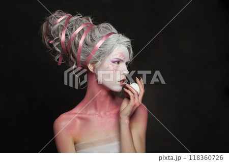 Creative beautiful woman in carnival Halloween costume, theater actress 118360726