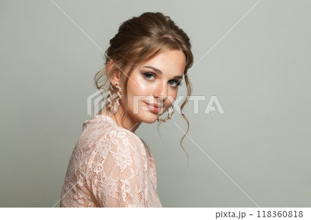 Cheerful elegance woman with fresh skin, updo hair and makeup on white background. Cheerful elegance woman with fresh skin, updo hair and makeup on white background. 118360818
