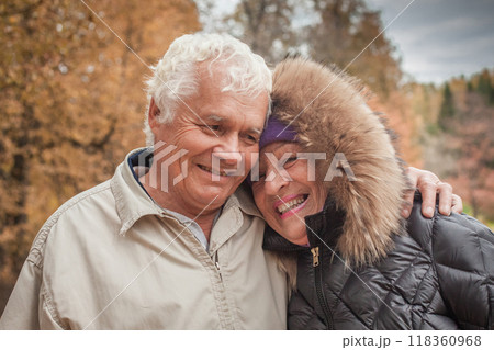 Laughing senior couple in autumn park, portrait Laughing senior couple in autumn park, portrait 118360968