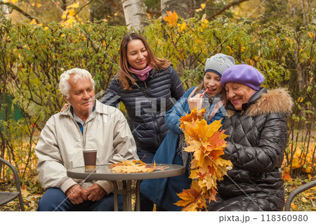 Happy family relaxing outdoor in autumn Happy family relaxing outdoor in autumn 118360980
