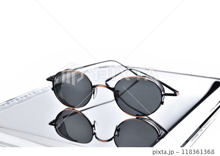 Sun glasses, stylish sunglasses on mirrored reflective background, close-up Sun glasses, stylish sunglasses on mirrored reflective background, close-up 118361368