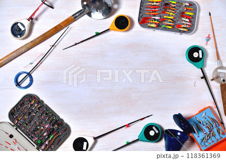 accessories for winter fishing on a light wooden background, place for an inscription 118361369