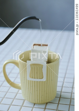 yellow cup freshly brewed coffee with convenient drip filter on table. prepare freshly brewed coffee yellow cup freshly brewed coffee with convenient drip filter on table. prepare freshly brewed coffee 118361499