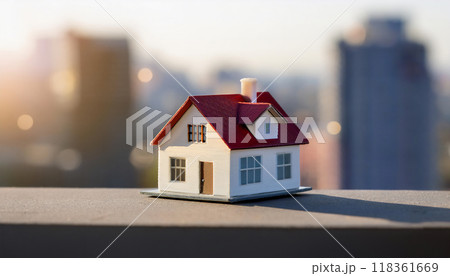一戸建ての家の模型。住宅や不動産の売買や相場のイメージ。都市の高層ビルの背景。 118361669