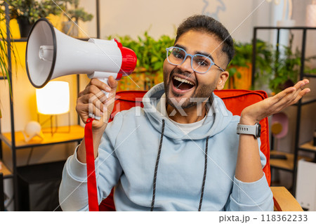 Indian man talking with megaphone, proclaiming news, loudly announcing advertisement promotion sale 118362233