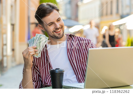 Happy rich man counting money dollar cash menu app ordering food, delivery online in city cafeteria Happy rich man counting money dollar cash menu app ordering food, delivery online in city cafeteria 118362262