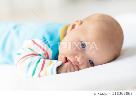 Little baby on white bed 118362868
