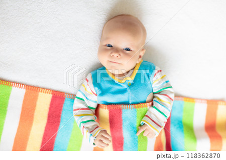 Little baby on white bed 118362870