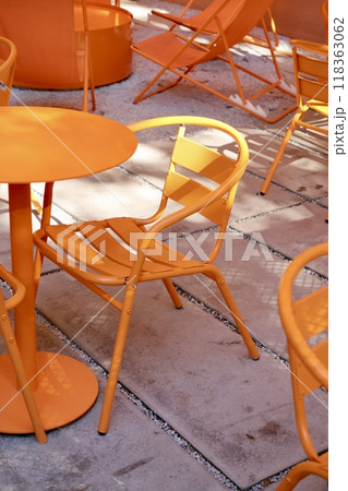 Coffee shop restaurant, orange furniture tables and chairs for guests. cozy street with cafe tables Coffee shop restaurant, orange furniture tables and chairs for guests. cozy street with cafe tables 118363062