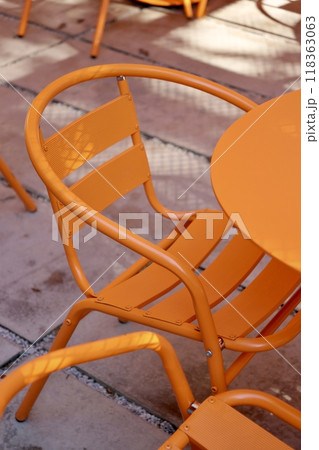 Coffee shop restaurant, orange furniture tables and chairs for guests. cozy street with cafe tables Coffee shop restaurant, orange furniture tables and chairs for guests. cozy street with cafe tables 118363063
