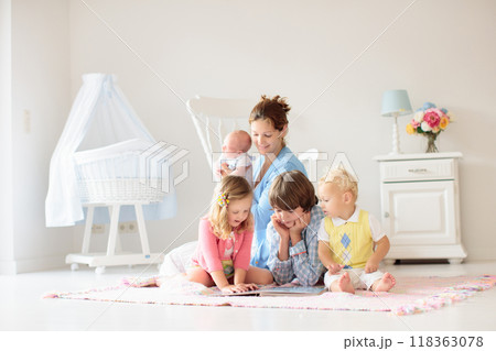 Family with kids playing with newborn baby Family with kids playing with newborn baby 118363078