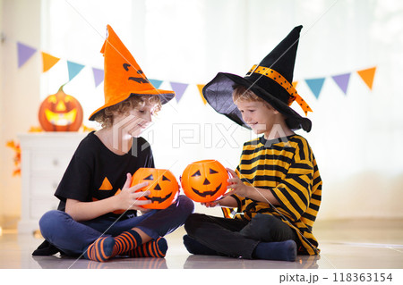Kids in witch costume on Halloween trick or treat 118363154