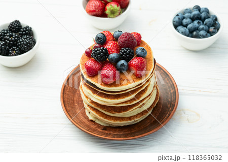 Stack of homemade american pancakes with berries . Top view 118365032