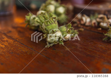 A pile of hazelnuts on a table outside 118365168