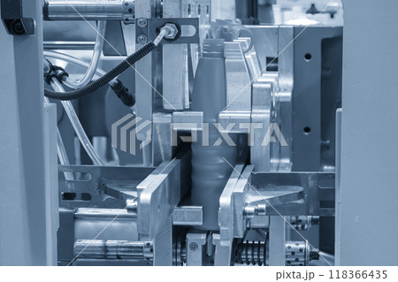 The blow mold machine operation in the light blue scene. 118366435