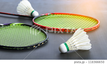Badminton shuttlecocks with rackets on a dark background symbolizing the spirit of exercise and global competition the essence of athleticism and the pursuit of excellence in the sport. 118366650