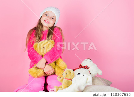 Kid little girl play with soft toy teddy bear pink background. Unique attachments to stuffed animals. Child small girl playful hold teddy bear plush toy. Teddy bears improve psychological wellbeing Kid little girl play with soft toy teddy bear pink background. Unique attachments to stuffed animals. Child small girl playful hold teddy bear plush toy. Teddy bears improve psychological wellbeing 118367656